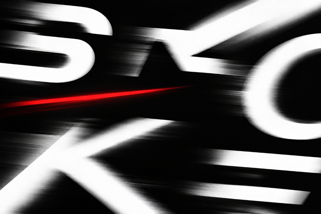 Cropped white geometric letterforms in motion with a red streak on black